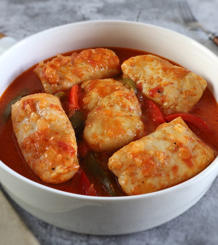 Hake in tomato sauce with peppers in a dish bowl