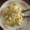 Chicken with spaghetti, pineapple and mushrooms in a plate
