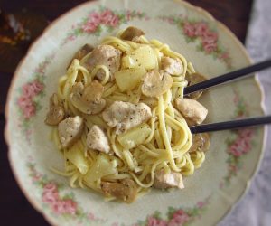 Chicken with spaghetti, pineapple and mushrooms in a plate