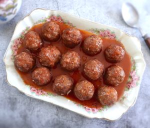 Homemade meatballs in tomato sauce on a platter