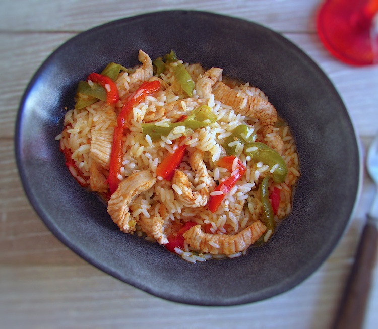 Turkey steaks with peppers and rice in a dish bowl