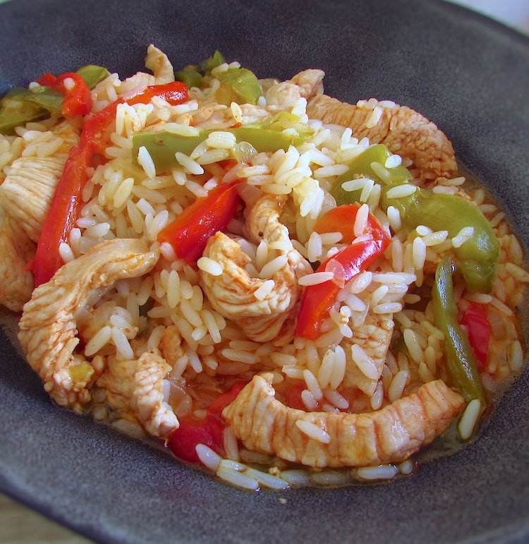Turkey steaks with peppers and rice in a dish bowl